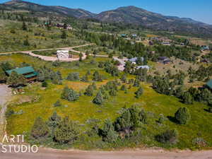 Aerial view of property and surrounding area featuring mountains