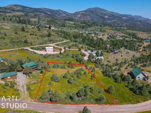 View of rural area with property parcel outlined and a mountain backdrop