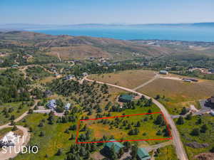 Aerial overview of property's location with property boundaries highlighted and a nearby body of water