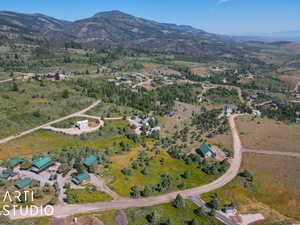 Aerial view of property and surrounding area with a mountain backdrop and rural landscape