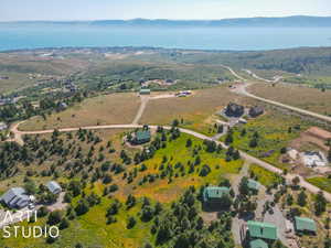 Aerial view of property and surrounding area featuring a mountain backdrop and rural landscape