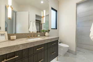 Full bathroom with vanity, a shower, and recessed lighting