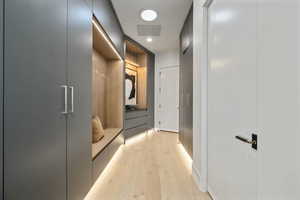Mudroom featuring light wood finished floors and recessed lighting