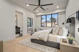 Bedroom with wood finished floors, recessed lighting, ensuite bath, and a ceiling fan