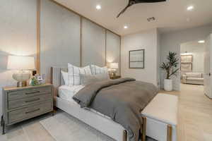 Bedroom with light wood-type flooring, recessed lighting, connected bathroom, and ceiling fan