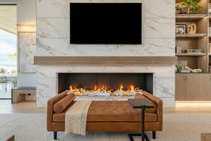 Detailed view of a fireplace and wood finished floors