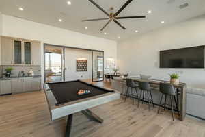 Playroom with billiards table, bar, recessed lighting, and light wood-style floors