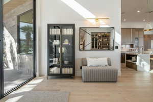 Sitting room featuring light wood-type flooring, recessed lighting, and a skylight
