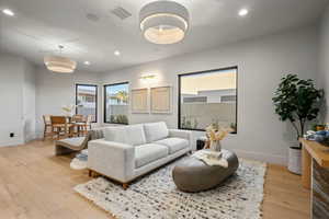 Living room featuring light wood finished floors and recessed lighting