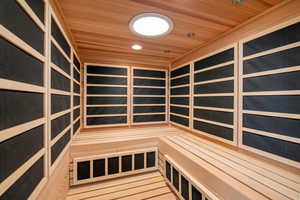 Relaxing sauna featuring wood ceiling and recessed lighting