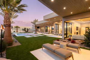 View of green lawn featuring an outdoor living space and a patio