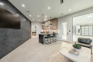 Living room featuring recessed lighting and an accent wall
