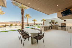 View of patio with exterior kitchen and a mountain view