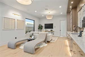 Living area featuring recessed lighting, light wood finished floors, and wine cooler