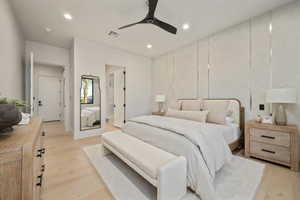 Bedroom featuring light wood finished floors, recessed lighting, ceiling fan, and connected bathroom