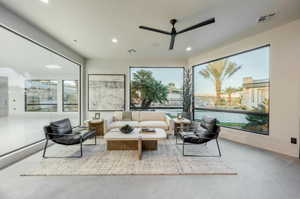 Living area featuring a ceiling fan, plenty of natural light, and recessed lighting
