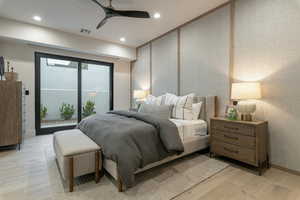 Bedroom featuring access to exterior, light wood-style flooring, recessed lighting, a ceiling fan, and wallpapered walls