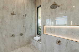 Bathroom with a marble finish shower