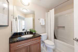 Bathroom with vanity, tile patterned flooring, and shower / tub combo with curtain