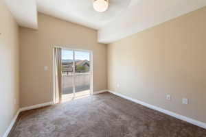 Carpeted spare room with baseboards