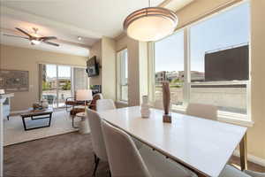 Carpeted dining room featuring baseboards and ceiling fan
