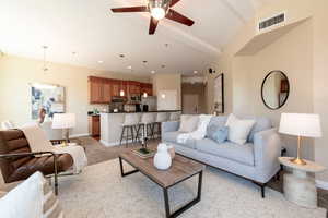 Living room with a ceiling fan, recessed lighting, and light carpet