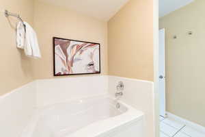 Full bathroom featuring a garden tub and tile patterned floors