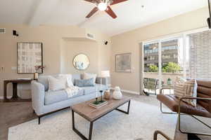 Living room featuring light carpet and ceiling fan