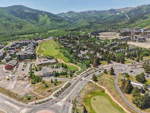 Aerial view of property and surrounding area featuring a mountain backdrop