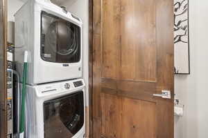 Laundry area featuring stacked washing machine and dryer