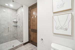 Full bathroom with a shower stall, tile patterned floors, and recessed lighting