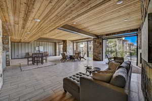 Living area with wood ceiling, a fireplace, and recessed lighting