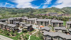Aerial overview of property's location featuring a mountainous background