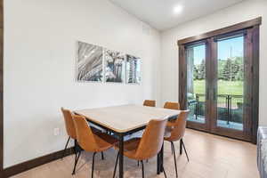 Dining room featuring french doors and light wood-type flooring