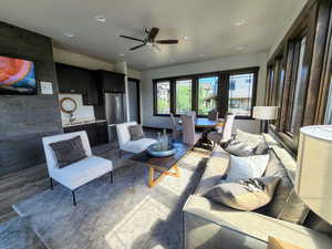 Living room with ceiling fan and recessed lighting