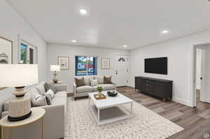 Living area featuring recessed lighting and light wood-style flooring