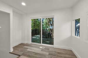 Spare room with wood finished floors and recessed lighting