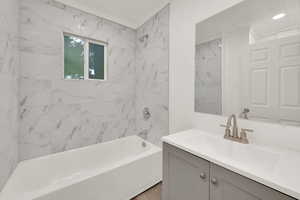 Bathroom featuring shower / bath combination and vanity