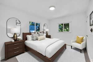 Bedroom with multiple windows and carpet flooring