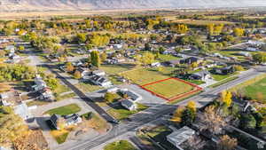 Aerial view of residential area featuring property boundaries highlighted and mountains