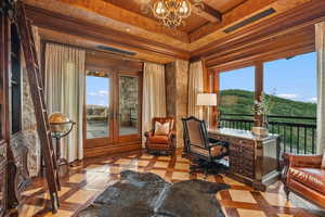Office with a wooden ceiling with exposed beams, inlaid floor details, a chandelier, and crown molding