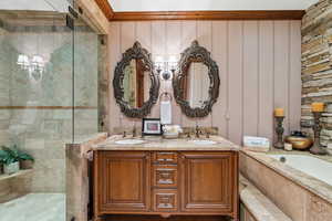 Bathroom featuring a garden tub, a tile shower, and double vanity