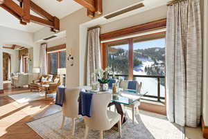 Dining space with arched walkways and wood-type flooring