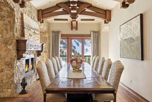 Dining area featuring a fireplace, hardwood / wood-style floors, and arched walkways