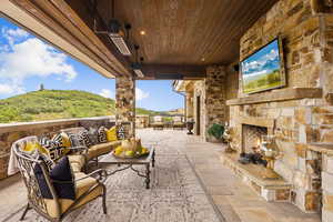 View of patio with an outdoor living space with a fireplace
