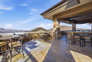 View of patio with outdoor dining space and a mountain view