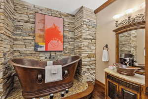 Bathroom with a soaking tub and vanity