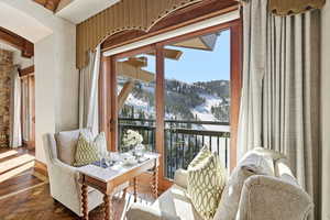 Snow covered back of property with a mountain view