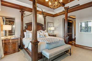 Bedroom featuring ornamental molding, light floors, a chandelier, decorative columns, and wood ceiling