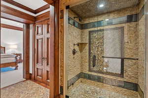 Bathroom with a stall shower, crown molding, connected bathroom, and recessed lighting